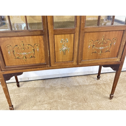 1431 - An Edwardian 2 door glass display cabinet with glazed & panel door, shaped top, tapered legs & spade... 