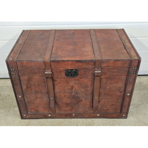 1433 - A large light weight wooden cabin trunk with metal handles and leather strap buckle detail. Approx. ... 