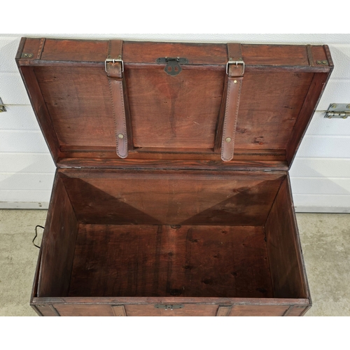 1433 - A large light weight wooden cabin trunk with metal handles and leather strap buckle detail. Approx. ... 