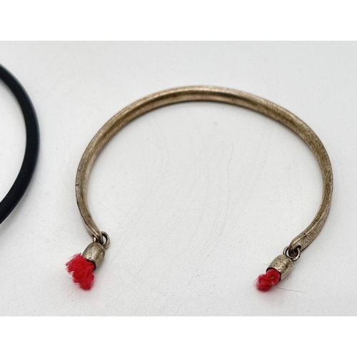 1250 - 2 silver bracelets. A modern design silicone bracelet with long silver barrel bead and spiral decora... 