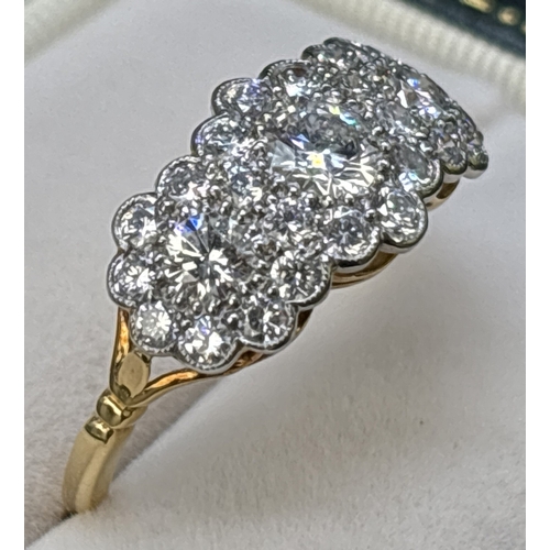 An 18ct gold & diamond triple cluster ring set with 27 brilliant cut ...