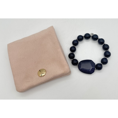 1015 - A blue sandstone elasticated bracelet by Lola Rose. Round sandstone beads with alternating silver to... 