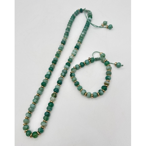 1017 - A faceted bead banded green agate necklace and matching bracelet, by Lola Rose. Both made from round... 