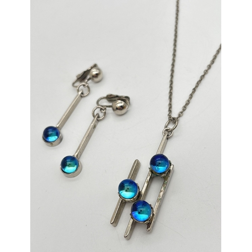 1024 - A vintage contemporary design pendant necklace and matching clip-on drop earrings. All set with blue... 