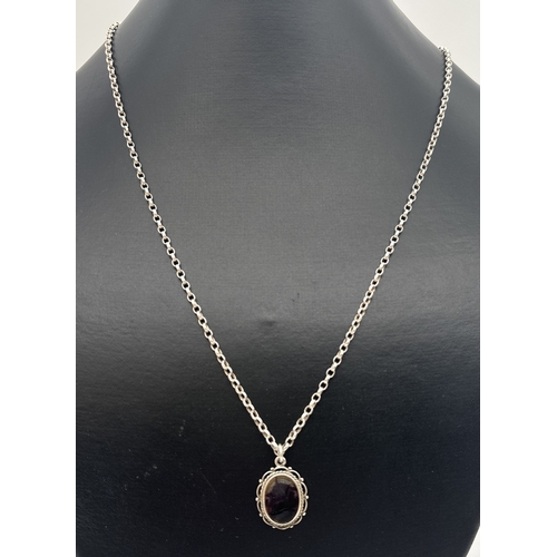 1028 - A vintage silver oval shaped pendant set with Blue John, on a 20