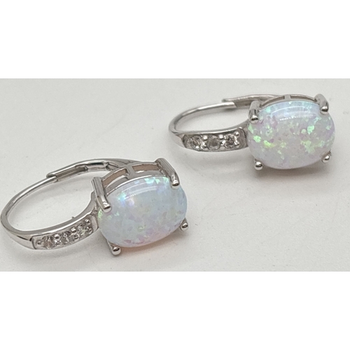 1043 - 3 pairs of silver gem stone set earrings. A pair of circular studs set with blue topaz, a pair of am... 