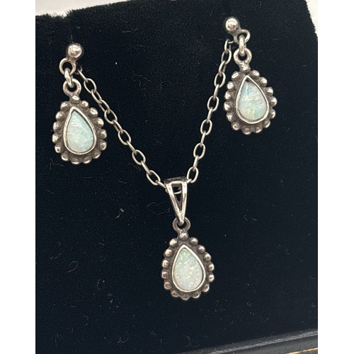 1045 - A silver teardrop shaped opal set pendant necklace with matching drop earrings. Pendant and earrings... 