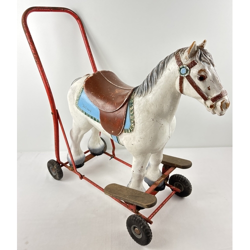 42 - A vintage 1950's child's push along/ride on horse by Tri-ang. A painted white hard plastic horse on ... 
