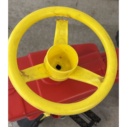 43 - A vintage white plastic ride on Case tractor, together with a red and yellow smaller ride on tractor... 