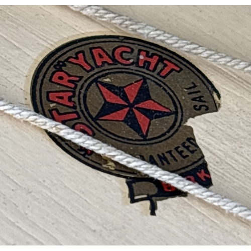 55 - 2 Star pond yachts. SY4 painted in cream and black, blue painted metal fin, mast and sails. Together... 