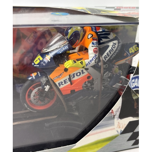 20 - 2 boxed Scalextric Moto GP motorcycles with riders. Valentino Rossi Repsol Honda C6000 together with... 