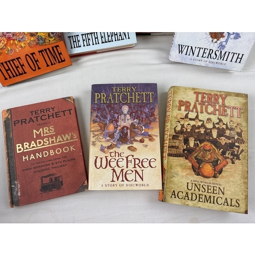 31 - A collection of 11 hardback and 14 paperback Terry Pratchett Discworld novels. All First Editions ap... 