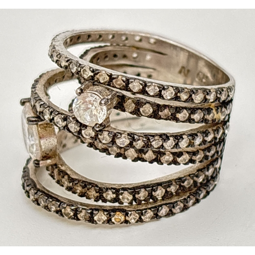 A wide multi band silver cocktail ring set with various sized round cut ...