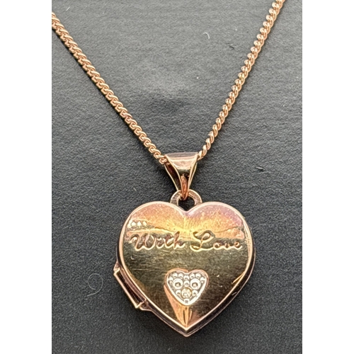 1102 - A rose gold on silver heart shaped locket set with small diamond and engraved 'With Love'. Comes on ... 