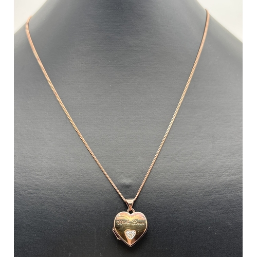 1102 - A rose gold on silver heart shaped locket set with small diamond and engraved 'With Love'. Comes on ... 