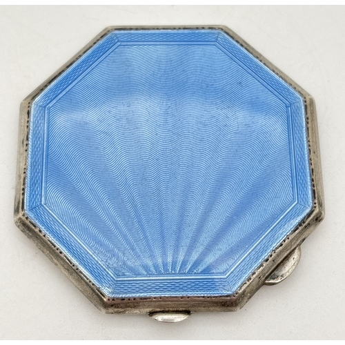 A George VI octagonal shaped silver compact with pale blue fanned ...