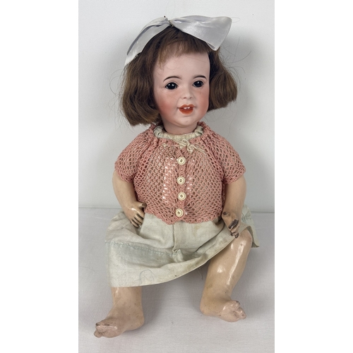 256 - A vintage bisque head Laughing Jumeau doll with composition body and jointed limbs. Closing brown ey... 