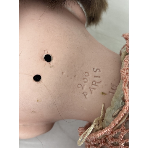 256 - A vintage bisque head Laughing Jumeau doll with composition body and jointed limbs. Closing brown ey... 