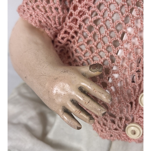 256 - A vintage bisque head Laughing Jumeau doll with composition body and jointed limbs. Closing brown ey... 