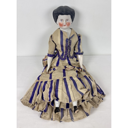 259 - A large antique ceramic head French doll with soft body and ceramic arms and legs. With hand painted... 