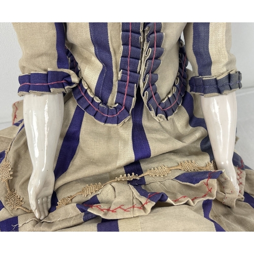 259 - A large antique ceramic head French doll with soft body and ceramic arms and legs. With hand painted... 