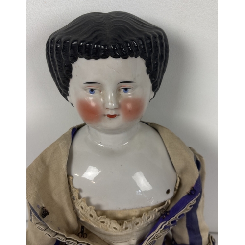 259 - A large antique ceramic head French doll with soft body and ceramic arms and legs. With hand painted... 