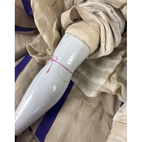 259 - A large antique ceramic head French doll with soft body and ceramic arms and legs. With hand painted... 