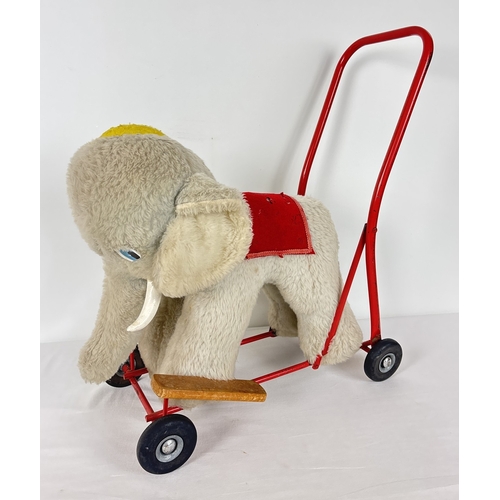 428 - A vintage plush ride on/push along toy elephant by Pedigree Soft Toys Ltd. Grey plush elephant with ... 