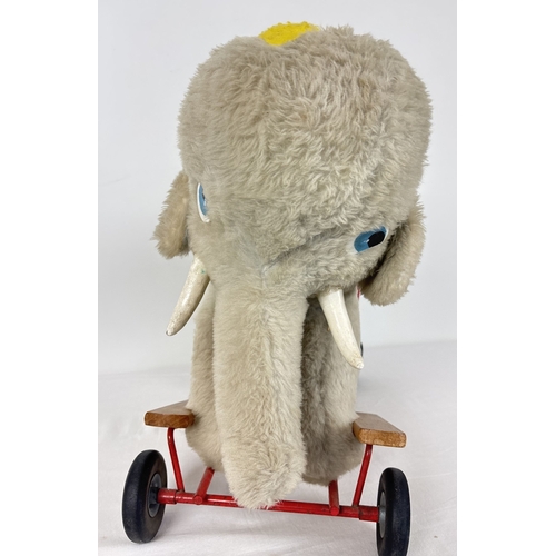 428 - A vintage plush ride on/push along toy elephant by Pedigree Soft Toys Ltd. Grey plush elephant with ... 