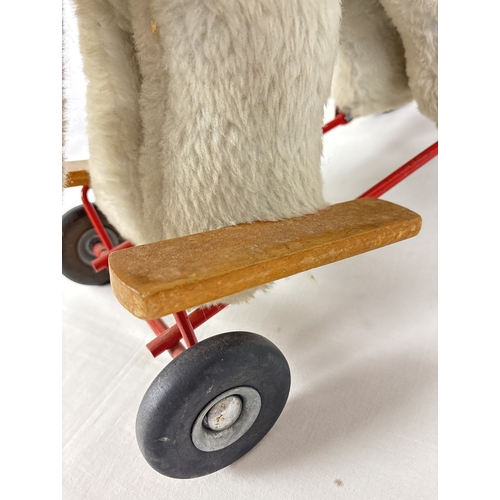 428 - A vintage plush ride on/push along toy elephant by Pedigree Soft Toys Ltd. Grey plush elephant with ... 