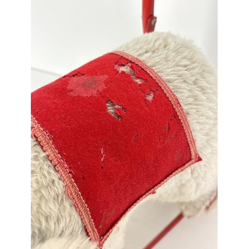 428 - A vintage plush ride on/push along toy elephant by Pedigree Soft Toys Ltd. Grey plush elephant with ... 