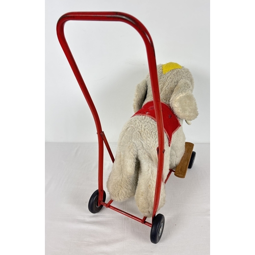 428 - A vintage plush ride on/push along toy elephant by Pedigree Soft Toys Ltd. Grey plush elephant with ... 