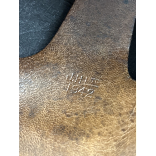 1266 - A World War II era leather pudding basin motorcycle helmet with integral leather neck, ear flaps and... 