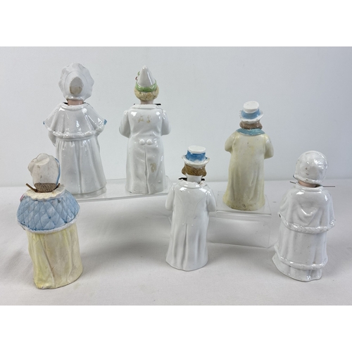1329 - 6 assorted antique bisque nodder figurines in varying designs and colours, to include a pair in yell... 