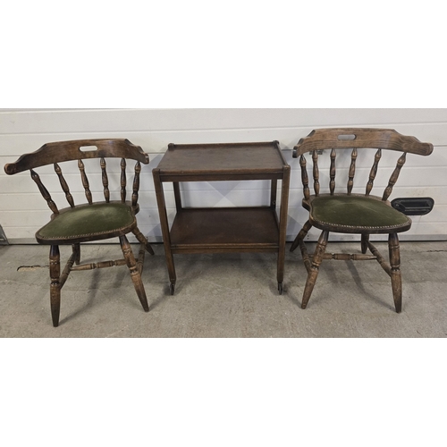 1338 - A pair of mid century bow back smokers together with a vintage dark wood 2 tier tea trolley with cas... 