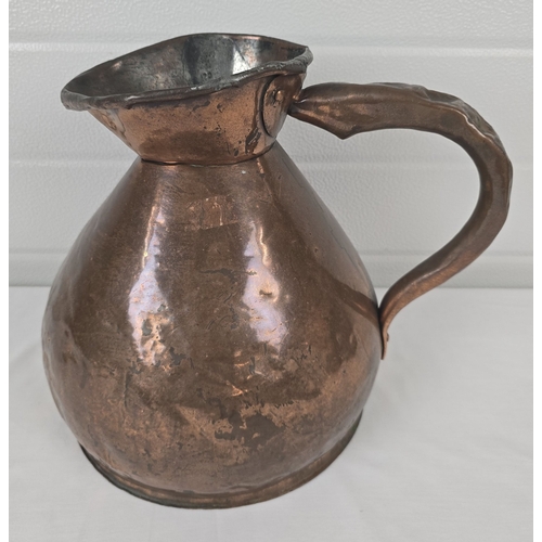A large Georgian copper harvest flagon with lead seal showing the GR crown mark. Some denting to handle. Approx. 30cm tall.