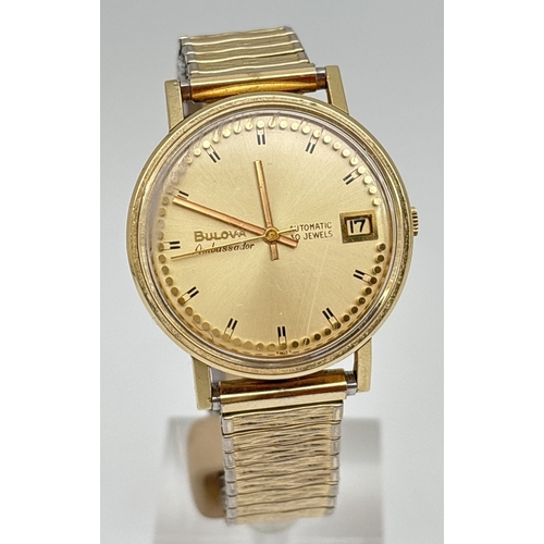 A men's vintage Ambassador automatic wristwatch by Bulova. Gold plated case with brushed gold face and black hour markers. Seconds hand and date function. In working order. On a gold plated expanding strap by Special.