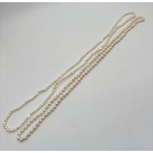 2 strings of freshwater cream lustre pearls. A string of smaller ...