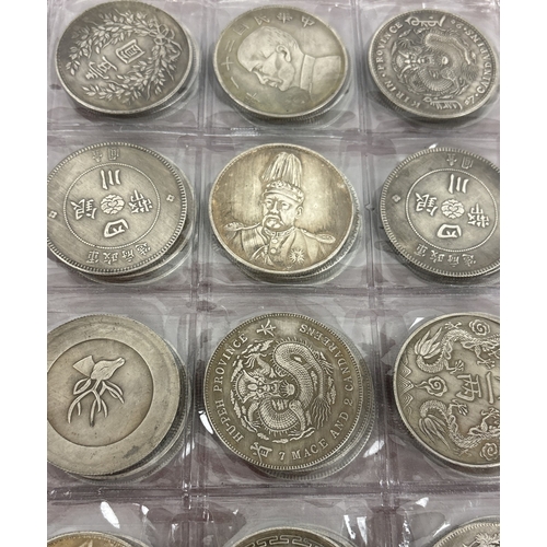 A folder containing 72 assorted reproduction Chinese coins. Folder ...