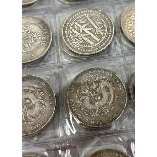 A folder containing 72 assorted reproduction Chinese coins. Folder ...