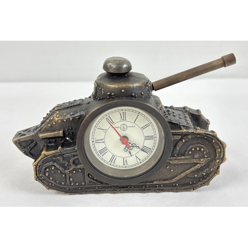 A brass cased winding desk clock modelled as a tank, with Roman Numeral ...