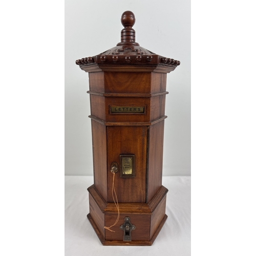 A wooden model of a replica Victorian hexagonal shaped post box. With ...