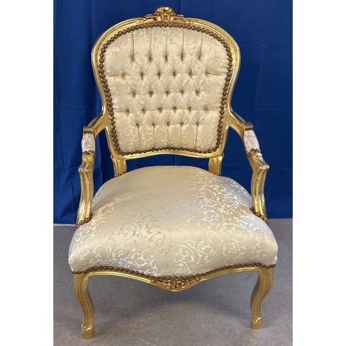 A modern wooden framed Louis XV style armchair, painted gold with cream coloured upholstery & button back detail. Approx. 92.5cm tall.