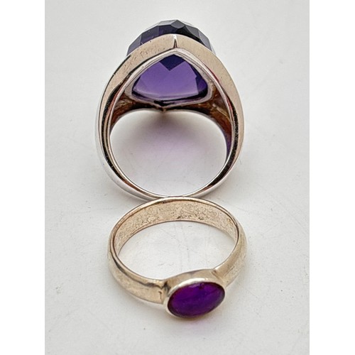1017 - 2 silver rings with purple stones. A large wide band statement ring set with a marquise cut faceted ... 