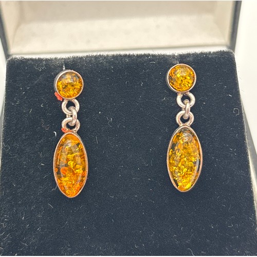 1018 - 2 pairs of silver drop style amber earrings. A pair of marquise cut honey amber drops suspended from... 