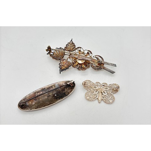1023 - 3 assorted vintage silver and white metal brooches. A 925 silver filigree butterfly, an 800 silver o... 