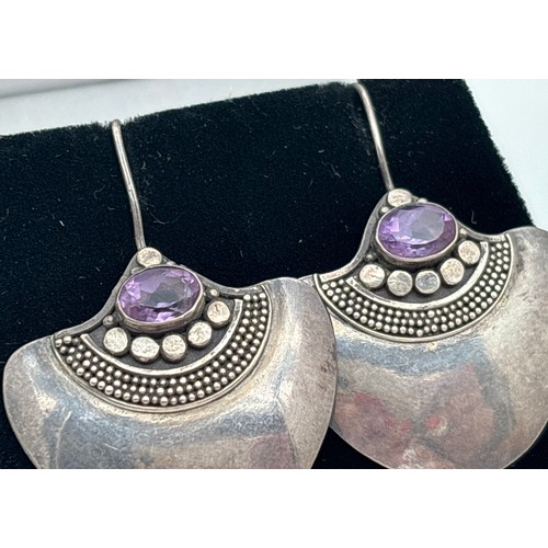 1025 - 2 pairs of statement silver earrings. A pair of large round studs set with a green speckled stone, m... 