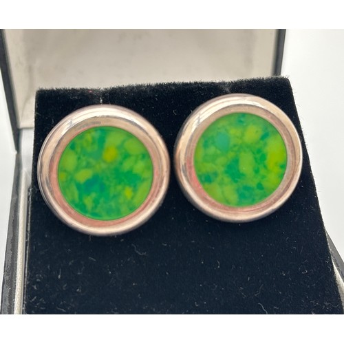 1025 - 2 pairs of statement silver earrings. A pair of large round studs set with a green speckled stone, m... 