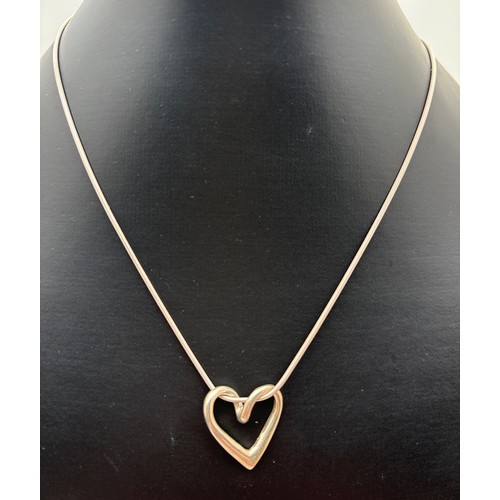 1027 - A boxed silver floating heart pendant, on a 16