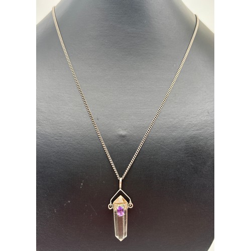 1030 - A clear quartz point pendant with silver cap and bale set with an oval cut amethyst, on a 20